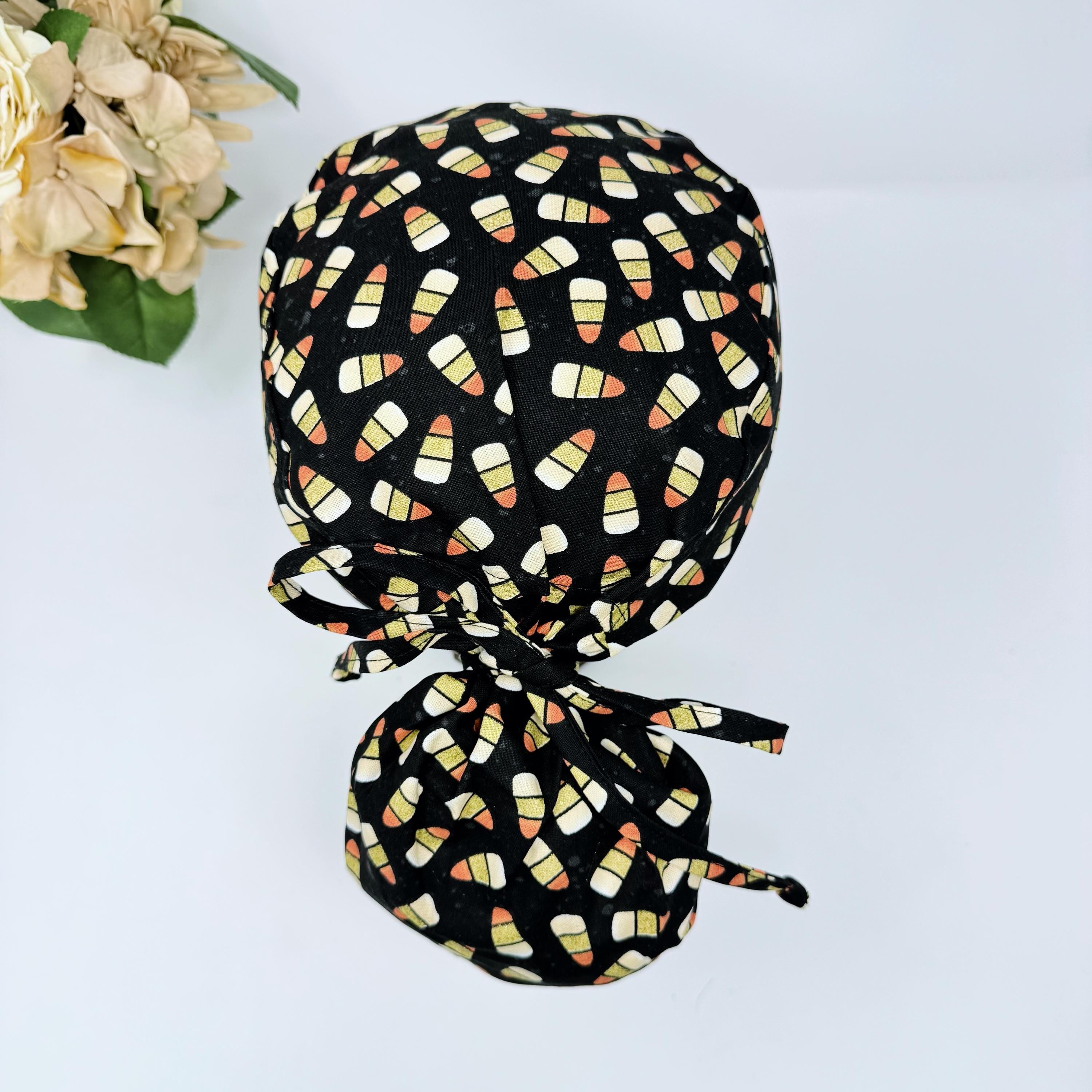 Trick-or-treat candy Ponytail scrub cap for women. Halloween Satin Lined Option Surgical cap with ponytail by Paradise Caps.