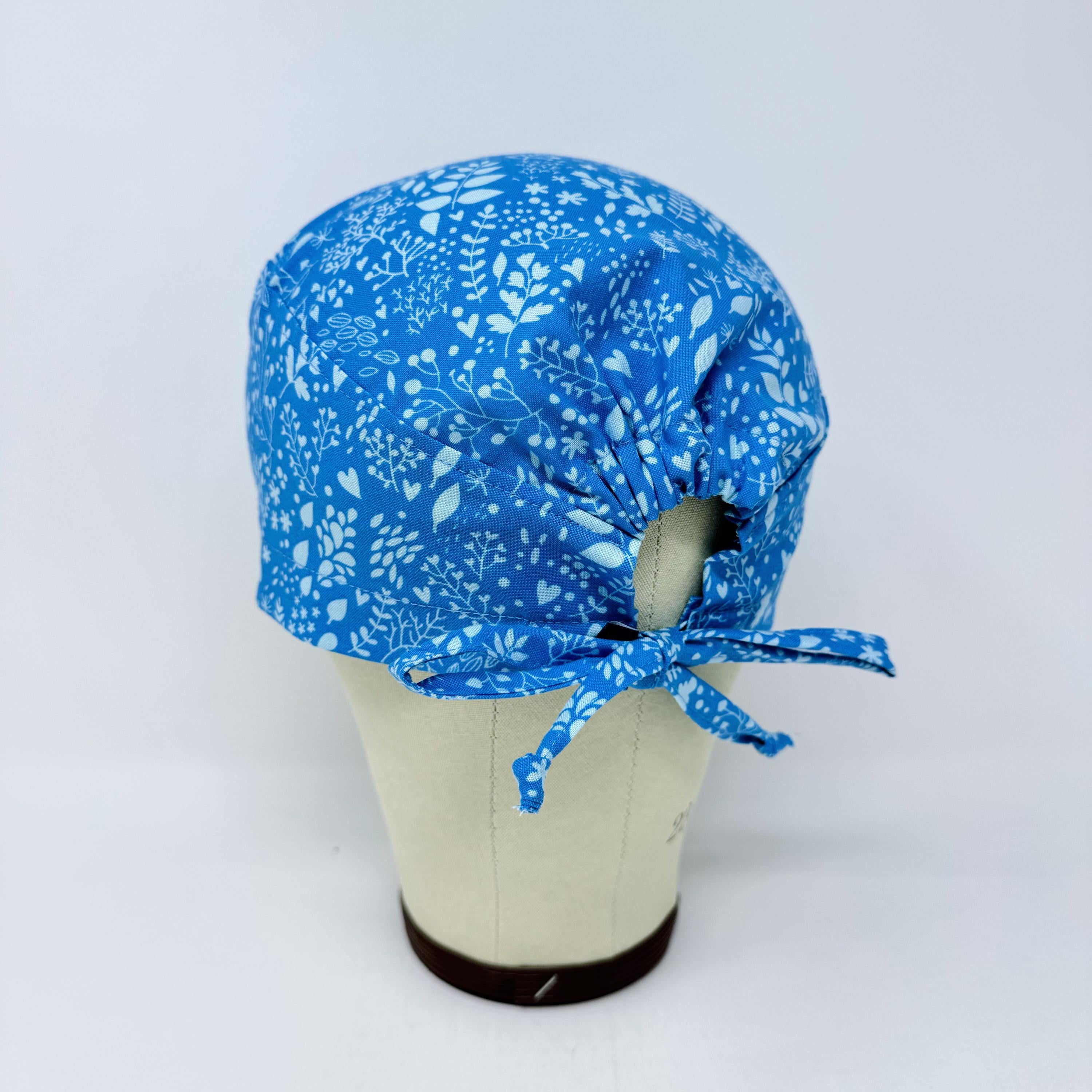 Calm Blue Floral Skull tie-back style surgical scrub cap by Paradise Caps.