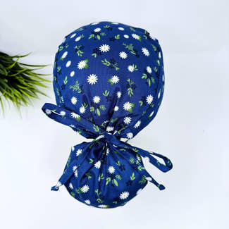 Ponytail scrub cap for women. Navy Daisy surgical hat for women with satin lined option by Paradise Caps.