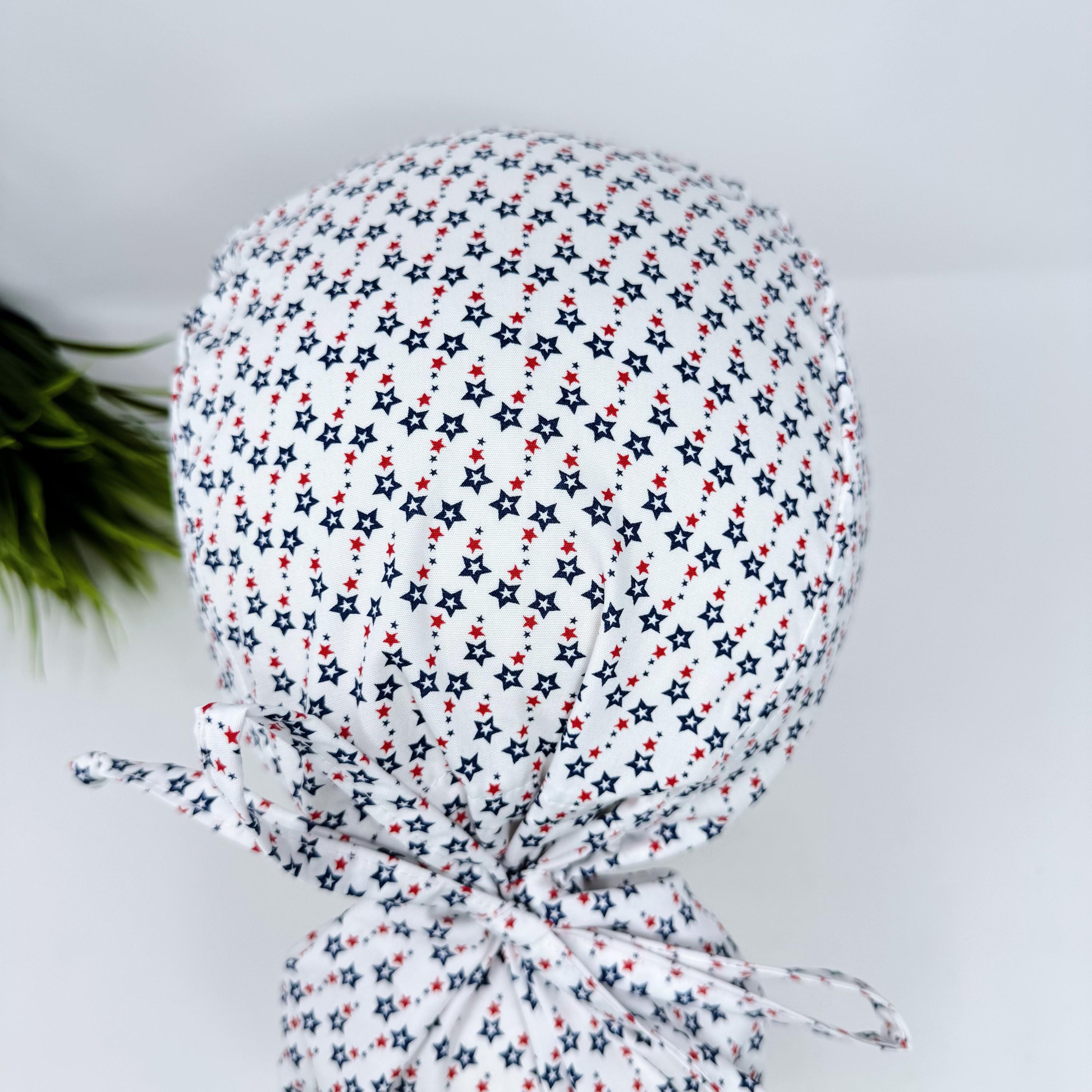 Ponytail scrub cap for women with satin lined option. Patriotic Stars Surgical hat with ponytail by Paradise Caps.