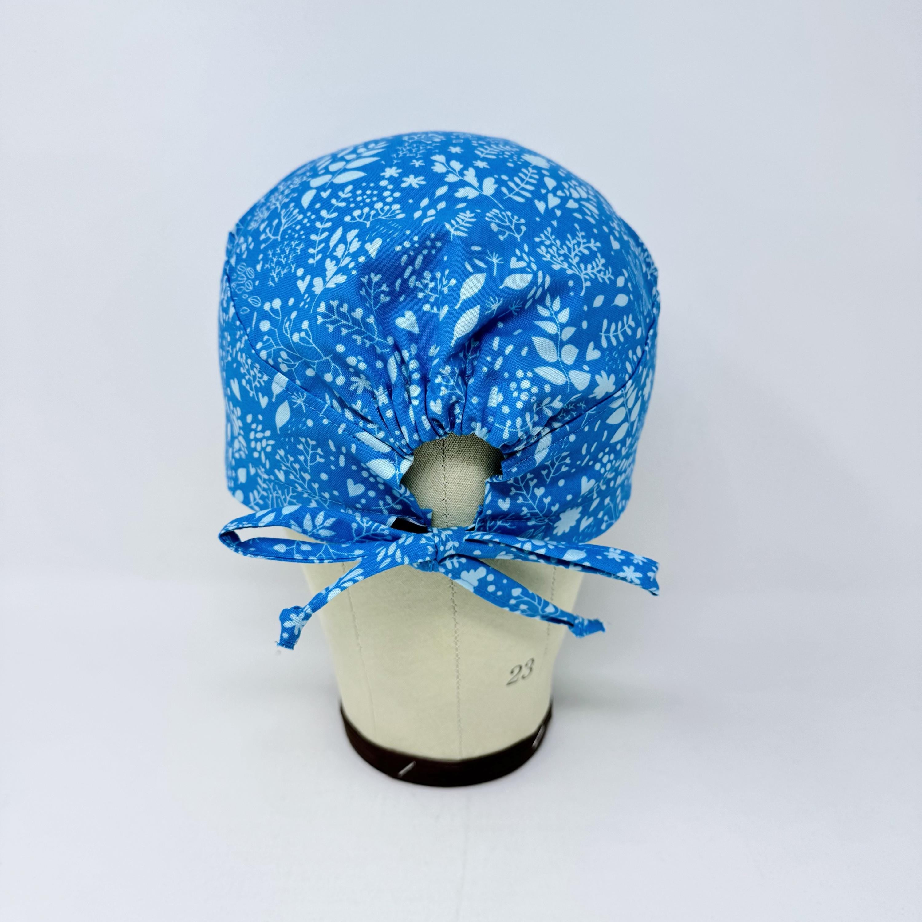 Calm Blue Floral Skull tie-back style surgical scrub cap by Paradise Caps.