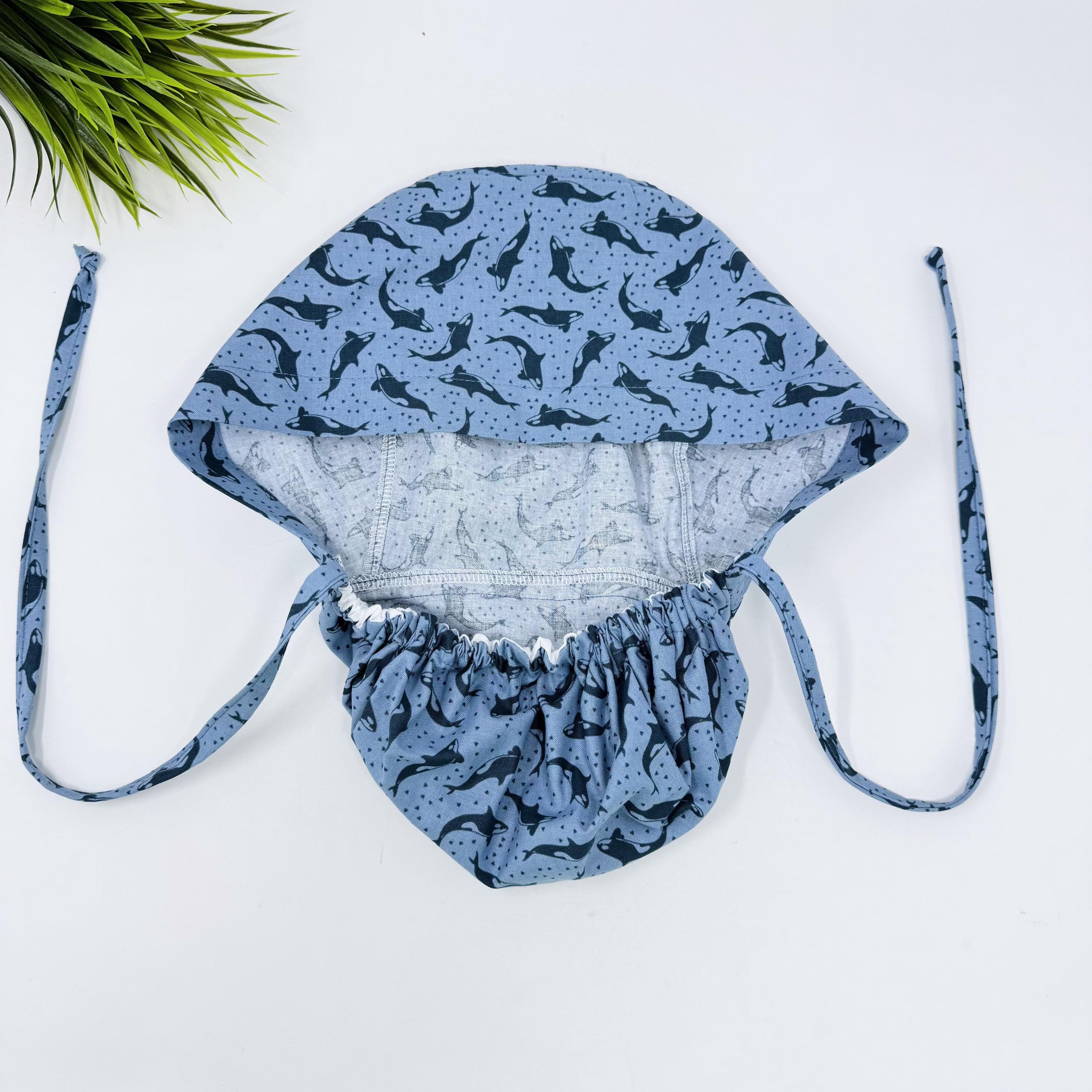 Ocean Orcas ponytail scrub cap women. Satin Lined option Ponytail scrub hat. Blue Sea Scrub caps for women by Paradise Caps.