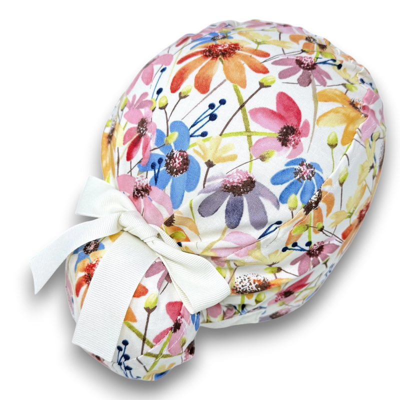 Paradise Caps women's Euro scrub cap with colorful floral print and white ribbon ties. 100% cotton.