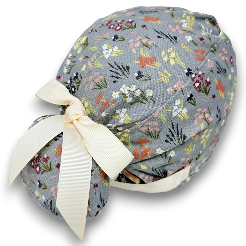 Paradise Caps grey Euro scrub cap with floral print and cream ribbon ties. 100% cotton, satin-lined.