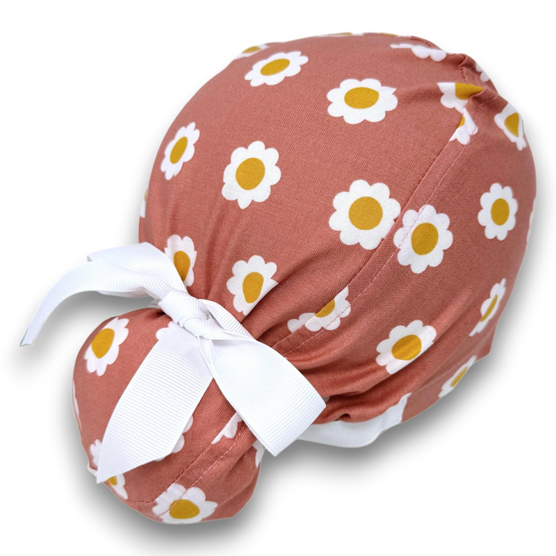 Paradise Caps coral Euro scrub cap with white daisy print and adjustable tie back. 100% cotton.