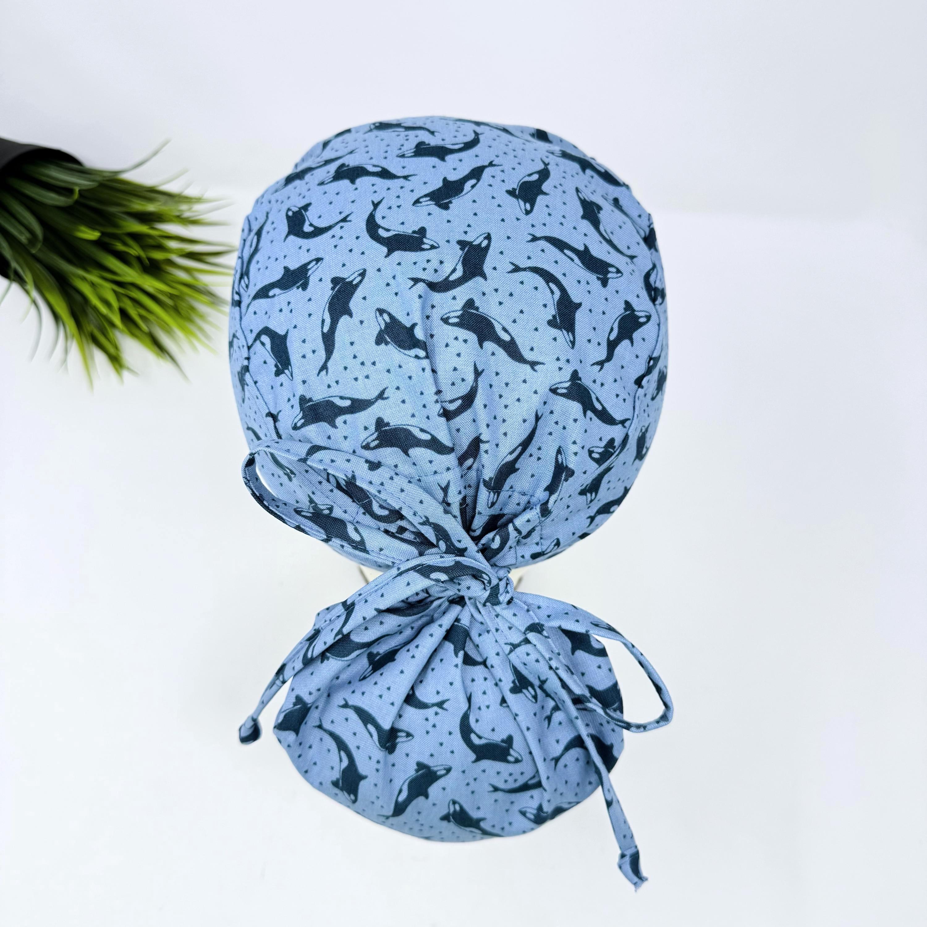 Ocean Orcas ponytail scrub cap women. Satin Lined option Ponytail scrub hat. Blue Sea Scrub caps for women by Paradise Caps.