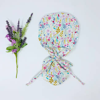 Flowers Ponytail scrub cap for women with satin lined option by Paradise Caps.